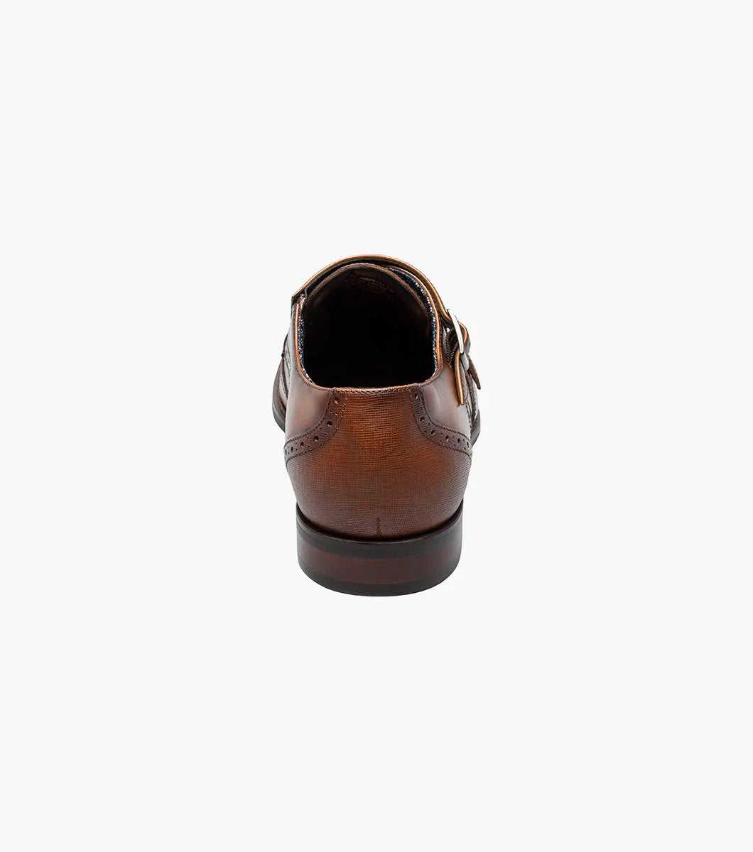 The STACY ADAMS Karson Wingtip Double Monk Strap dress shoe in Cognac features decorative perforations and a low heel, shown on a white background. Model: 25570-221.