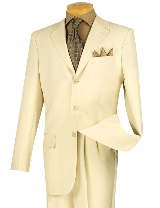 An ivory Vinci Suits Regular Fit 2 Piece 3 Button Suit, featuring a sleek blazer with a brown shirt, patterned tie, and pocket square, is elegantly showcased on a mannequin. The double-pleated pants offer style and easy alteration for any discerning gentleman.