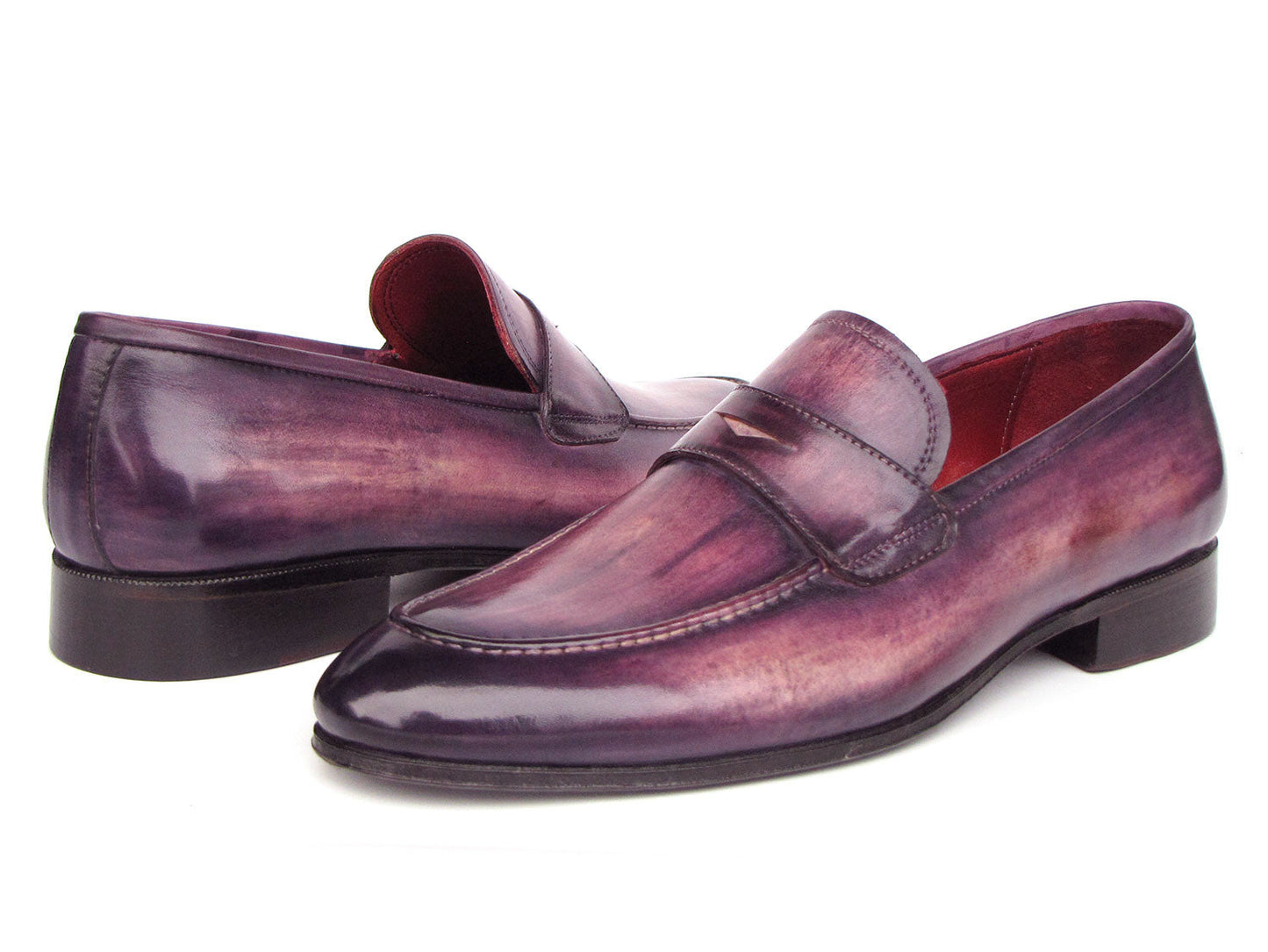 A pair of Paul Parkman Men's Purple Patina Penny Loafers - 17PRP33, crafted from hand-painted leather with a strap across the front, displayed on a white background.
