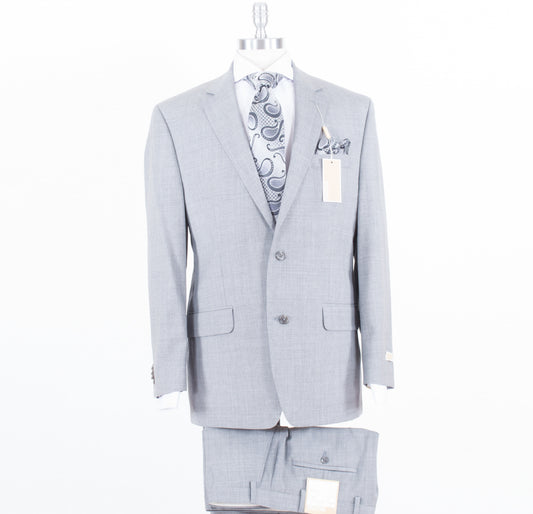 A Michael Kors Modern Fit Grey KEVI2K2Z1220 suit, complete with a paisley patterned tie and pocket square, elegantly displayed on a mannequin against a white backdrop. Tags are attached to the jacket.