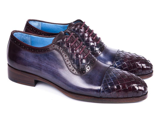 A pair of Paul Parkman Woven Leather Captoe Oxfords in Navy & Purple, meticulously crafted from hand-painted leather with intricate woven details and a gradient transition from dark blue to burgundy, featuring a low heel and blue interior lining.