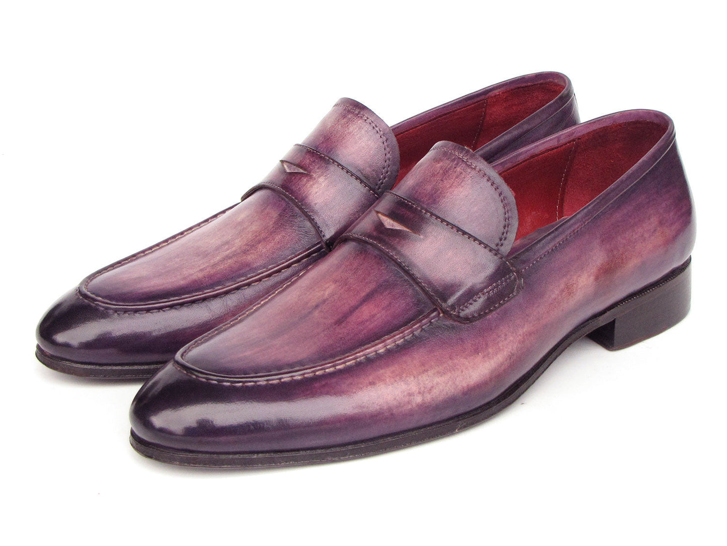 A pair of Paul Parkman Men's Purple Patina Penny Loafers - 17PRP33, crafted from hand-painted leather with a strap across the front, displayed on a white background.