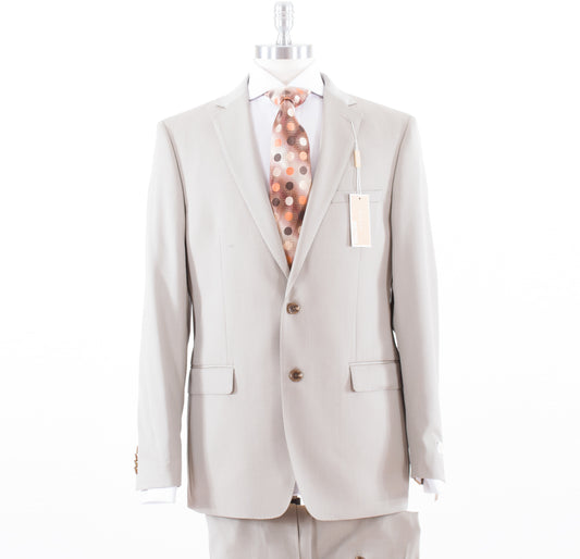 A stylish MICHAEL KORS mannequin showcases the modern fit Michael Kors Solid Tan KIEF2K2Z1404 wool suit, paired with a crisp white shirt and a chic polka dot tie.