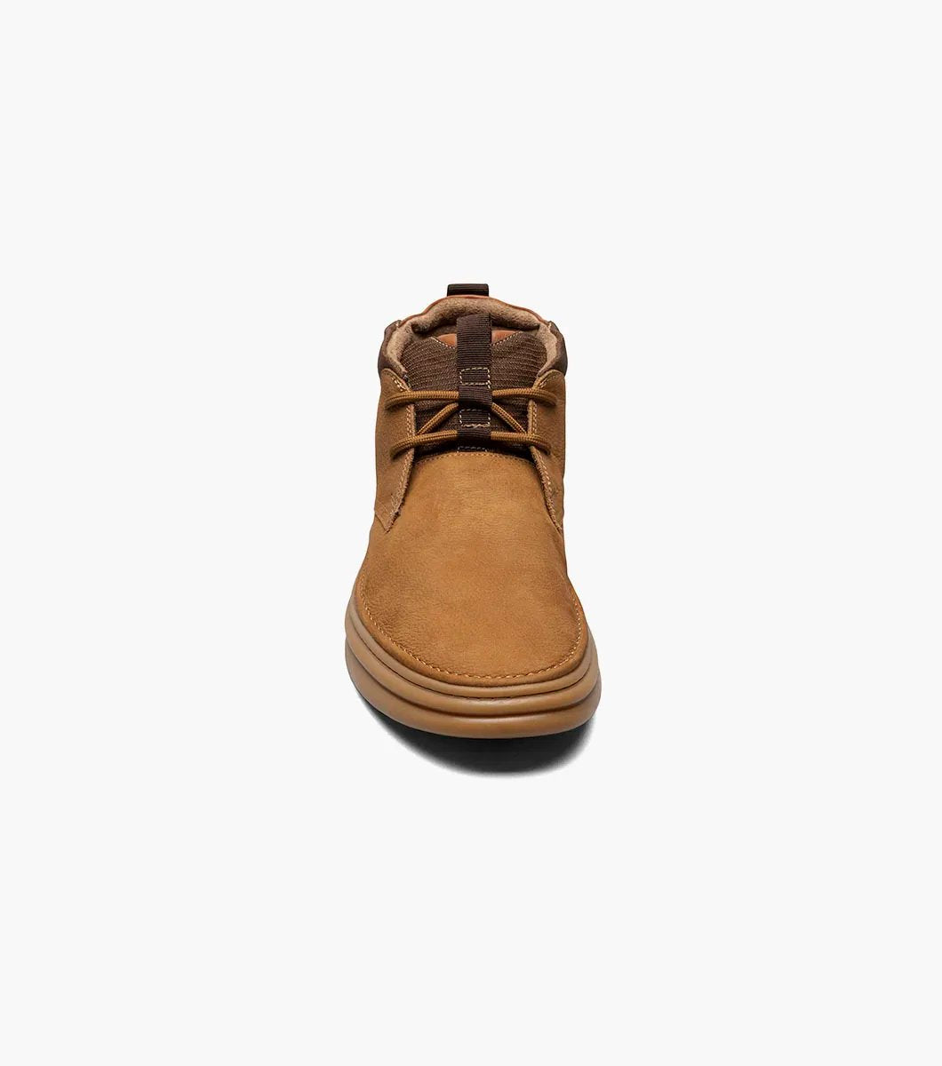 The Stacy Adams DELSON Plain Toe Chukka Boot in Camel (model 25556-228) has a durable rubber sole and lace-up front, offering anatomical arch support for all-day comfort against the crisp white background.