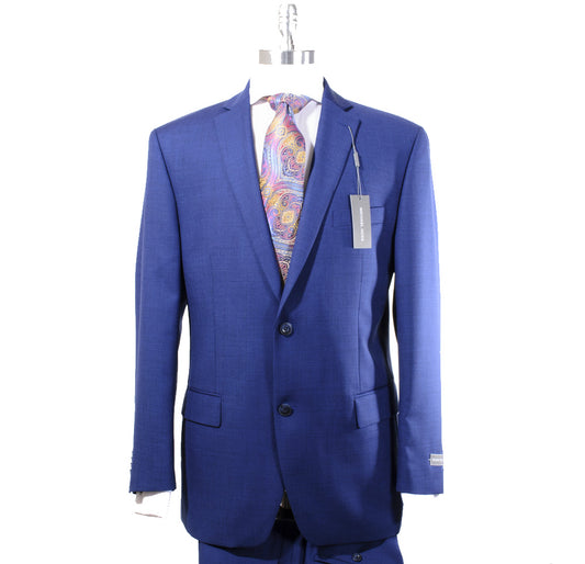 A Michael Kors Modern Fit Solid Blue KELS2K2Z2025 suit is displayed on a hanger, featuring full side vents and a notch lapel, paired with a colorful paisley tie and an attached tag.