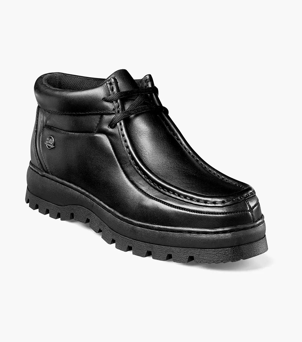 The STACY ADAMS Dublin II Moc Toe Boot (Black Smooth, 63169-57) features a lace-up design, thick textured sole, and classic moc toe style, shown here against a plain white background.
