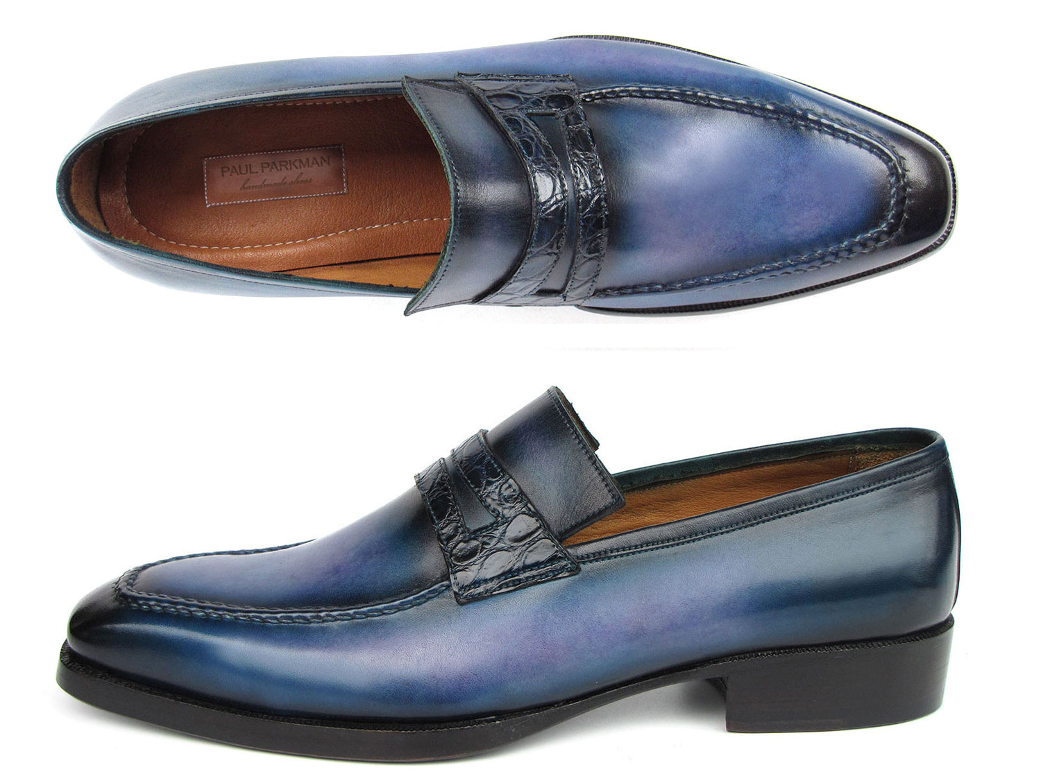 The Paul Parkman Men's Blue Patina Handmade Loafers (model 6944-BLU) feature a stunning design with a dark geometric strap detail and a subtle gradient. These loafers are crafted from hand-painted leather, constructed using the Goodyear welted method for exceptional quality and durability, complete with robust black soles.