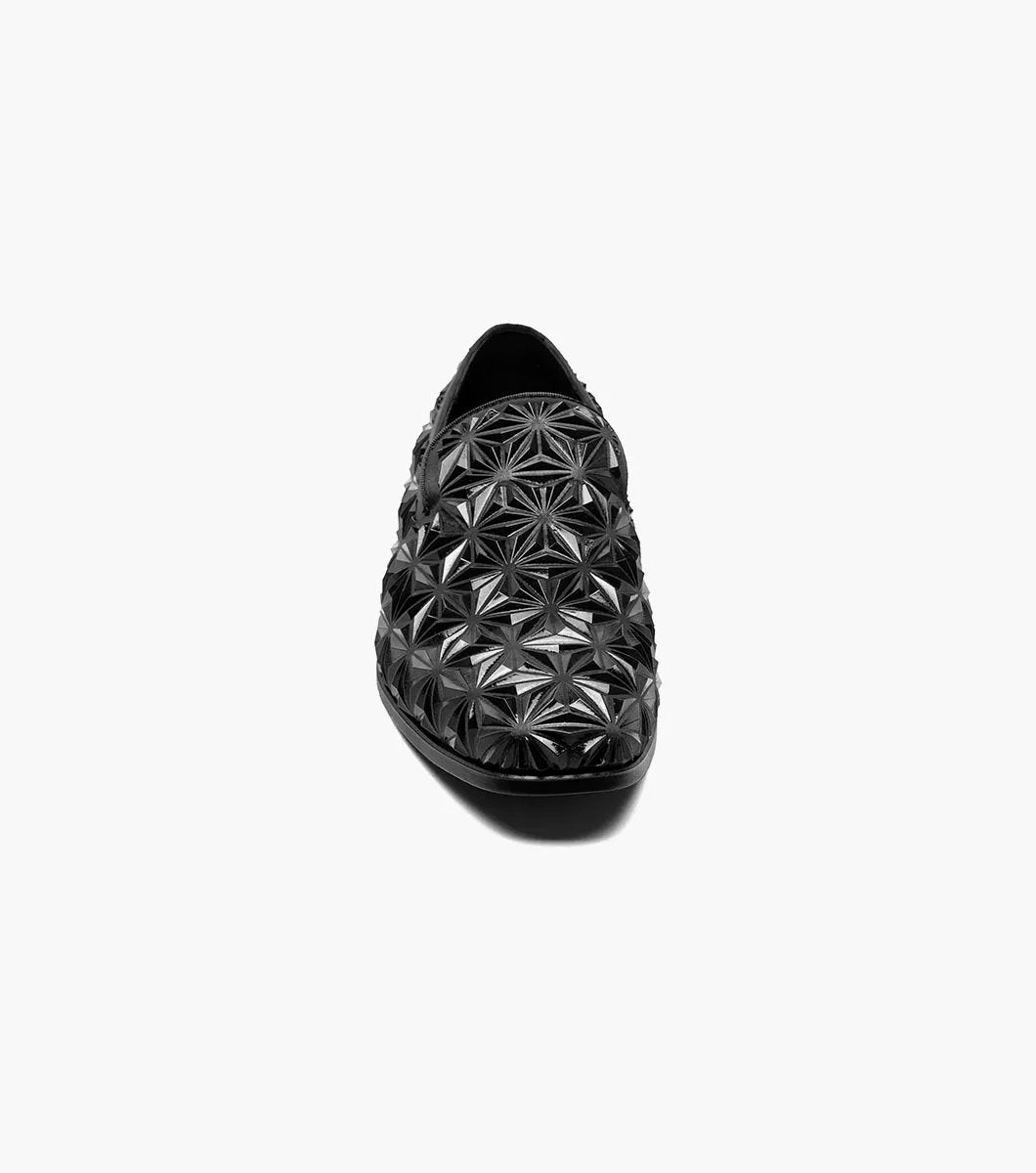 The Stacy Adams Sequence Plain Toe Slip On (25535-001) is a black dress shoe with a glossy geometric star pattern, memory foam insole, and low heel, shown against a plain white background.
