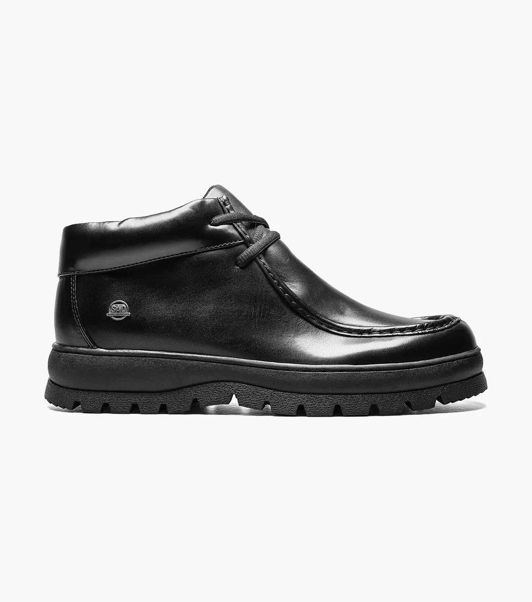 The STACY ADAMS Dublin II Moc Toe Boot (Black Smooth, 63169-57) features a lace-up design, thick textured sole, and classic moc toe style, shown here against a plain white background.