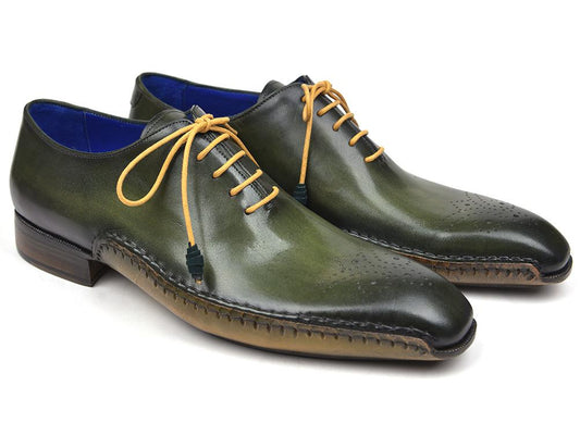 Paul Parkman presents the Opanka Construction Oxfords in green, elegantly crafted from hand-painted leather and boasting a medallion toe design. They feature tan laces and a striking blue lining, making them the perfect statement piece for any wardrobe.