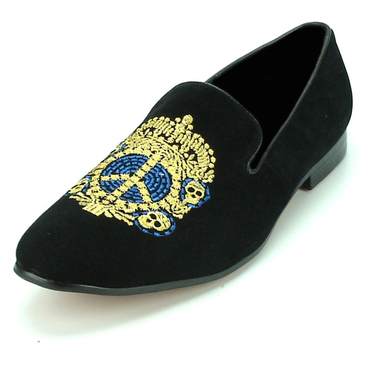 The FI-7181 Black Fiesso by Aurelio Garcia from Fiesso is a slip-on fashion shoe with a decorative gold and blue embroidered emblem on the leather upper, featuring a cushioned insole for added comfort.
