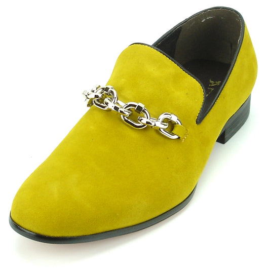 The FI-7191 Mustard Fiesso by Aurelio Garcia from the brand Fiesso is a yellow suede loafer with a cushioned insole, adorned with a silver chain on top, and features black trim along with a low heel.