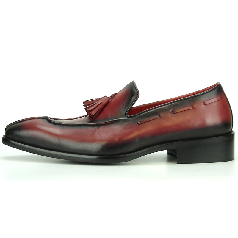 The FI-8701 Burgundy Encore by Fiesso is a polished leather loafer with a maroon hue, black gradient, and tassel detail on the instep that exemplifies high-fashion footwear, set against a plain background.