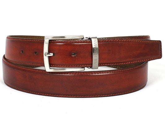 A customized Paul Parkman leather belt, hand-painted in a reddish-brown hue from Italian calfskin, featuring a silver buckle with an engraved logo and visible stitching, displayed coiled.