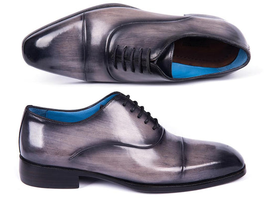 A pair of Paul Parkman Cap Toe Oxfords in gray burnished leather, showcasing a classic cap toe design and black laces, displayed side by side and viewed from the front.