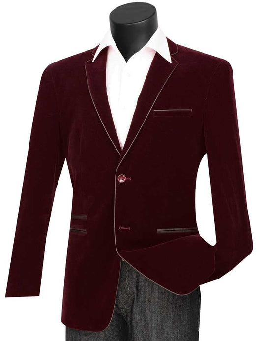The Vinci Suits Slim Fit Velvet Sport Coat (Wine) BS-02, featuring black lapels and piping, is styled over a crisp white shirt and paired with dark pants for a sleek ensemble.