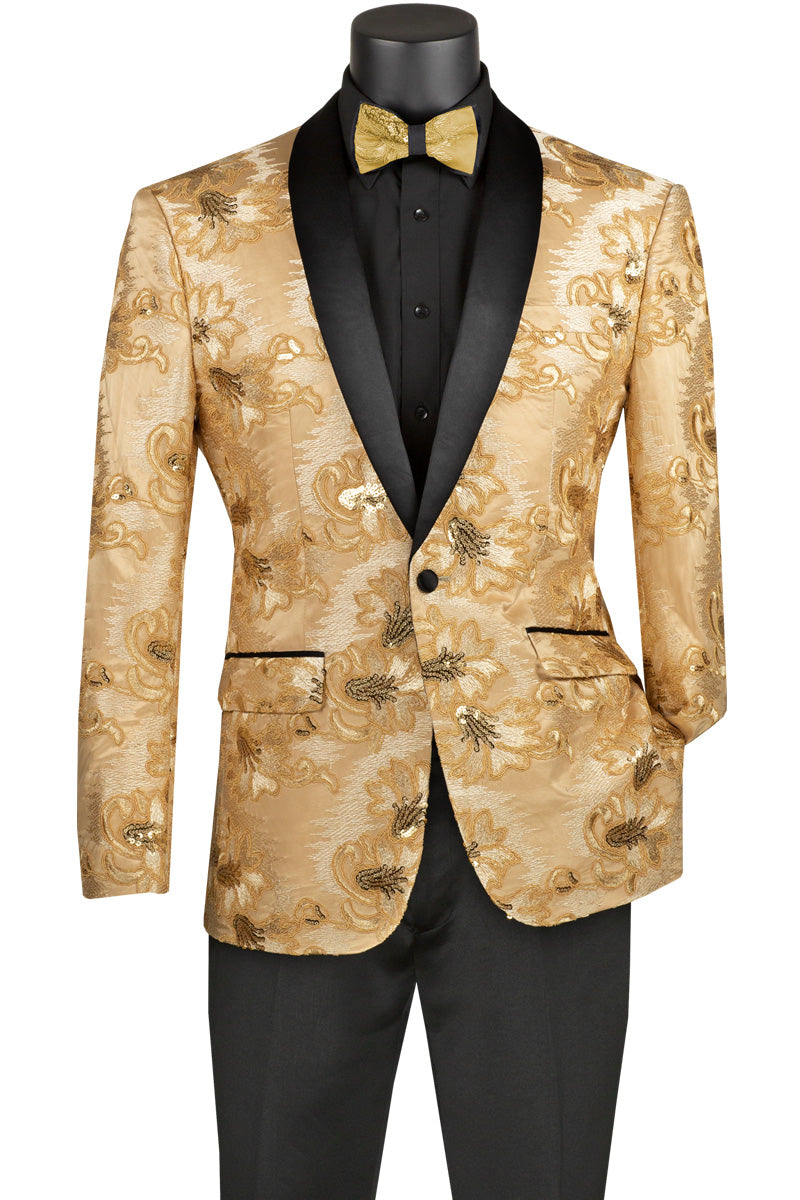 The Vinci Suits Slim Fit Embroidered Shawl Lapel with Bow Tie Jacket (Champagne Beige) BSF-13 features a gold floral pattern and black shawl lapels, complemented by a slim-fit black shirt and trousers, along with a matching gold bow tie.