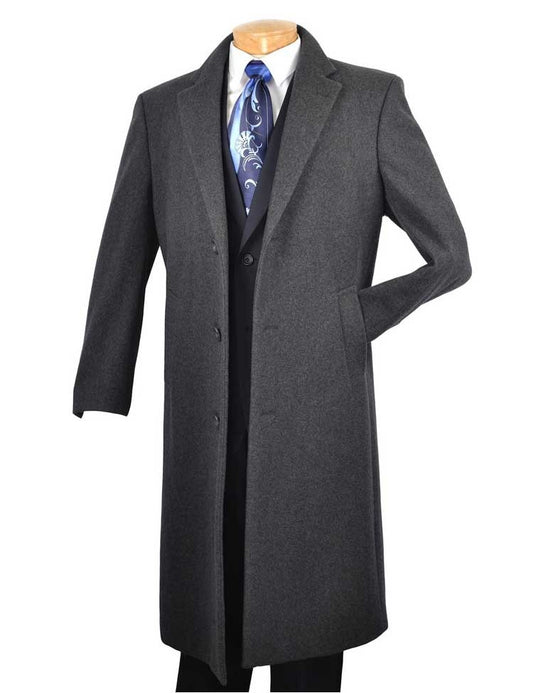 A luxuriously soft cashmere 48" Long Dress Top Coat (Charcoal) by Vinci Suits drapes elegantly over a black suit, paired with a crisp white shirt and a blue patterned tie, all displayed on a mannequin.