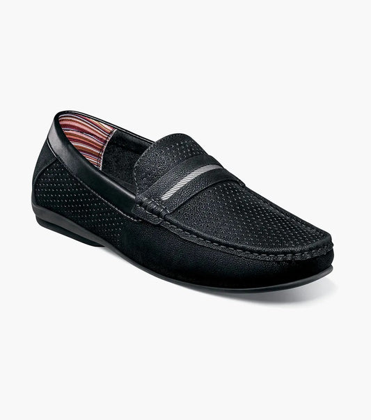 The STACY ADAMS Corby Moc Toe Saddle Slip On (Black, 25513-001) features black leather with perforated sides, a textured upper, striped band and lining, and a flat rubber sole—ideal for casual warm-weather wear.