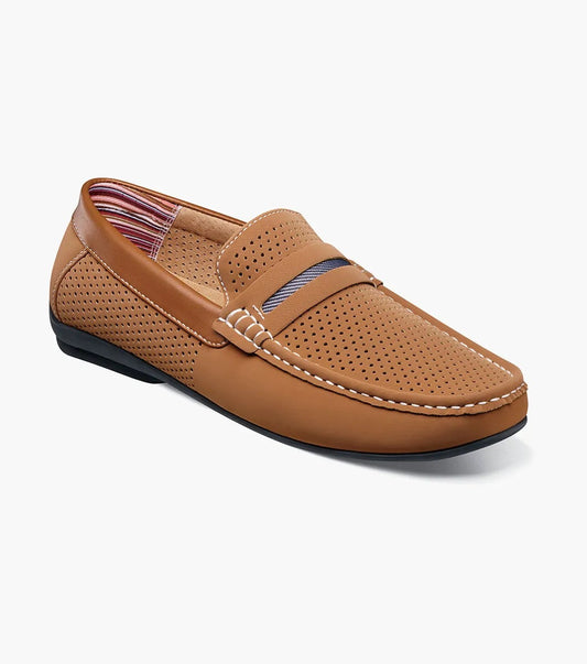 The Stacy Adams Corby Moc Toe Saddle Slip On in tan features perforated detailing, white stitching, a striped upper accent, leather lining, and a black sole—perfect for casual warm-weather wear.