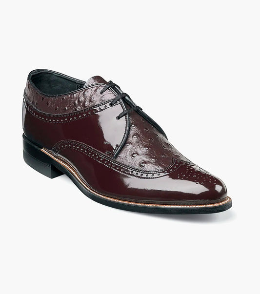 The STACY ADAMS Dayton Ostrich Wingtip Oxford in burgundy (00375-05) features a polished finish, decorative perforations, black laces, and a low heel; shown as a single dress shoe on a white background.