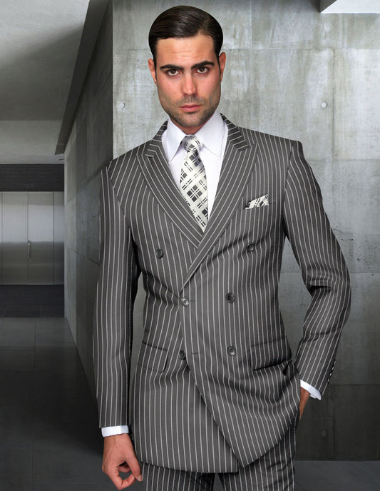 A man in a Statement Clothing DB-ZARELLI-GRAY suit stands in a modern hallway with one hand in his pocket, looking directly at the camera.