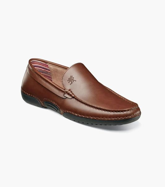 The Stacy Adams Del Moc Toe Loafer in brown (style 25533-200) features a black rubber sole, visible stitching, and striped interior lining, shown on a plain white background.
