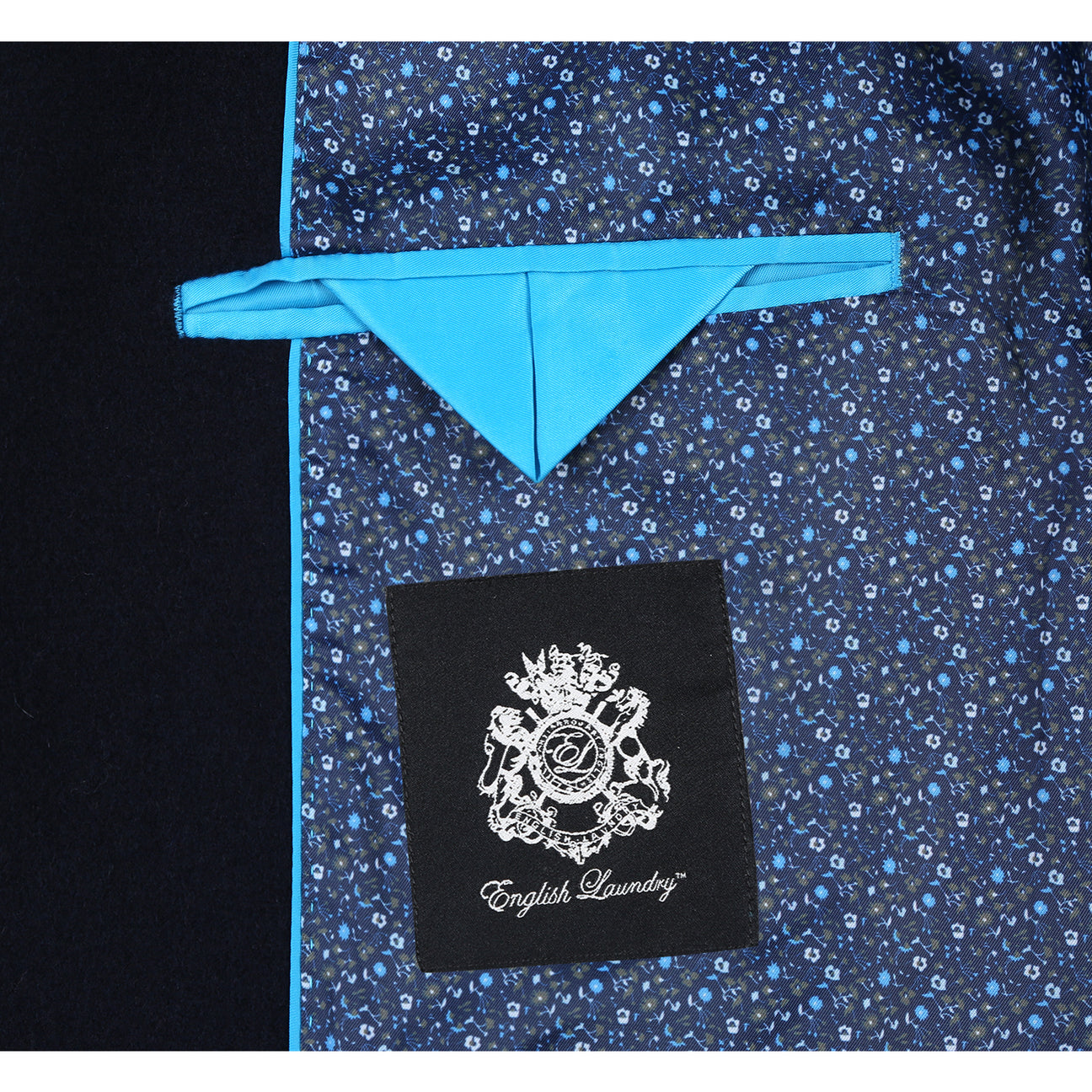 The ENGLISH LAUNDRY Wool Blend Breasted Navy Top Coat EL53-01-410 by English Laundry is a versatile choice that can perfectly complement a black suit jacket, a white shirt, and a black tie with small white dots, creating an elegant layered look suitable for any occasion.