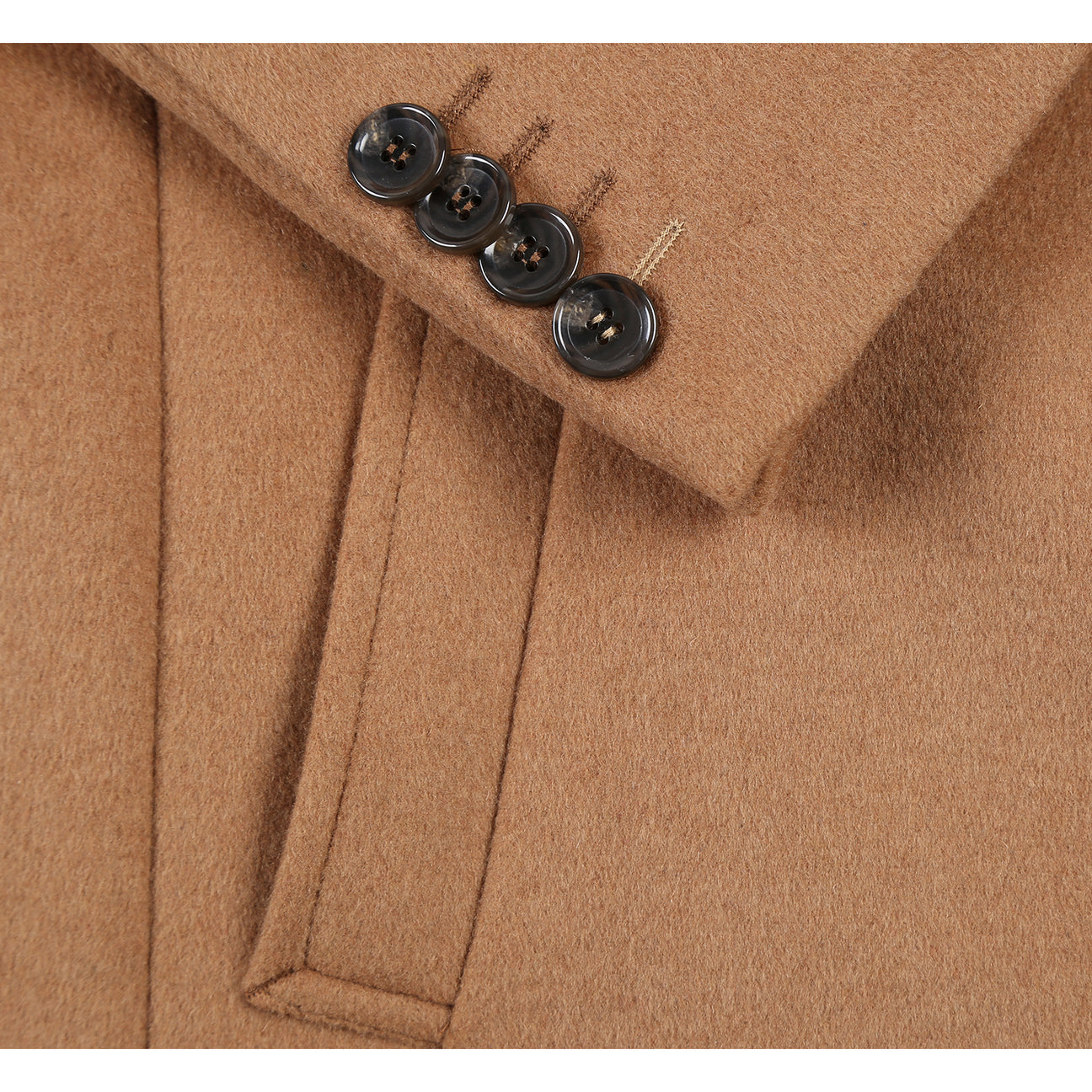 ENGLISH LAUNDRY's Wool Blend Breasted Camel Top Coat EL53-01-600 features a sleek single-breasted design, three buttons, notch lapels, and practical flap pockets. It pairs effortlessly with a crisp white shirt and a sophisticated navy polka dot tie.