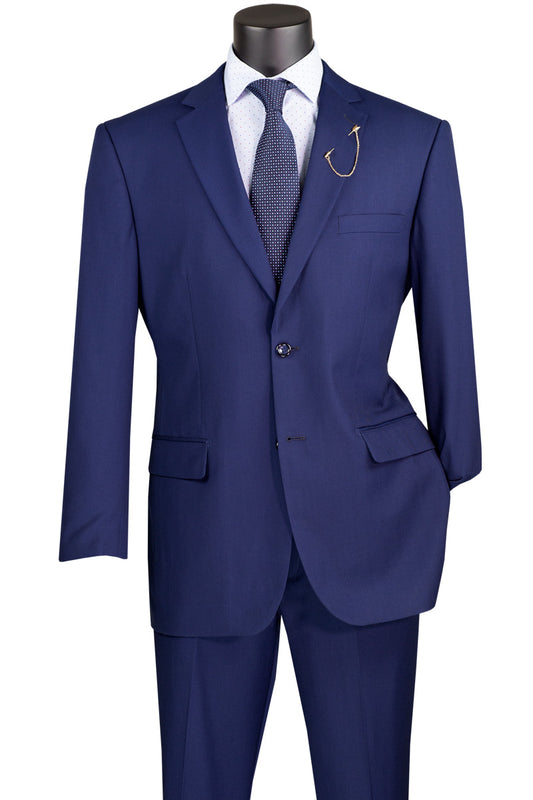 A Vinci Suits mannequin showcases the 2 Piece Suit with a 2″ adjustable waistband in Patriot Blue, paired with a polka dot tie and white shirt. A notch lapel design and large fishhook embellish the luxurious wool feel of the F-2C900 jacket.