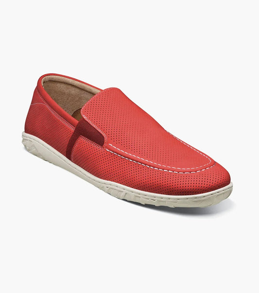 The Stacy Adams Ilan Perf Moc Toe Slip On in red (25512-600) features perforated detailing, white stitching, a white rubber sole, and breathable leather linings for comfort. Displayed on a plain white background.