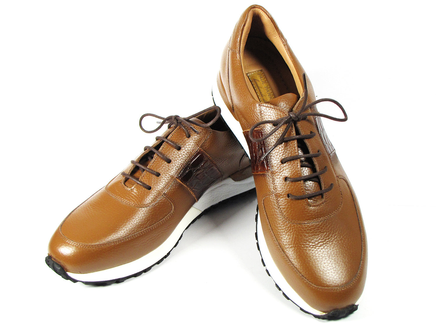 These Paul Parkman Men's Cognac Floater Leather Sneakers - LP206CGN feature a sleek brown leather design with cognac floater leather accents, complemented by white soles and dark brown laces, all beautifully showcased on a white background. Celebrate individuality with this made-to-order item from the Paul Parkman brand, perfect for those who value exceptional craftsmanship.