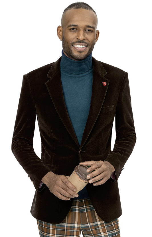 A man wearing an EJ Samuel Brown Velvet Blazer J134 with gold buttons and plaid pants, holding a coffee cup, is smiling against a neutral background.
