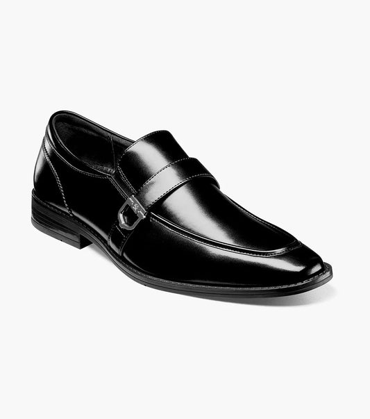 The Stacy Adams Kester Moc Toe Bit Loafer (20195-001) is a black leather men’s dress shoe with a buckle detail and low heel, displayed against a plain white background.