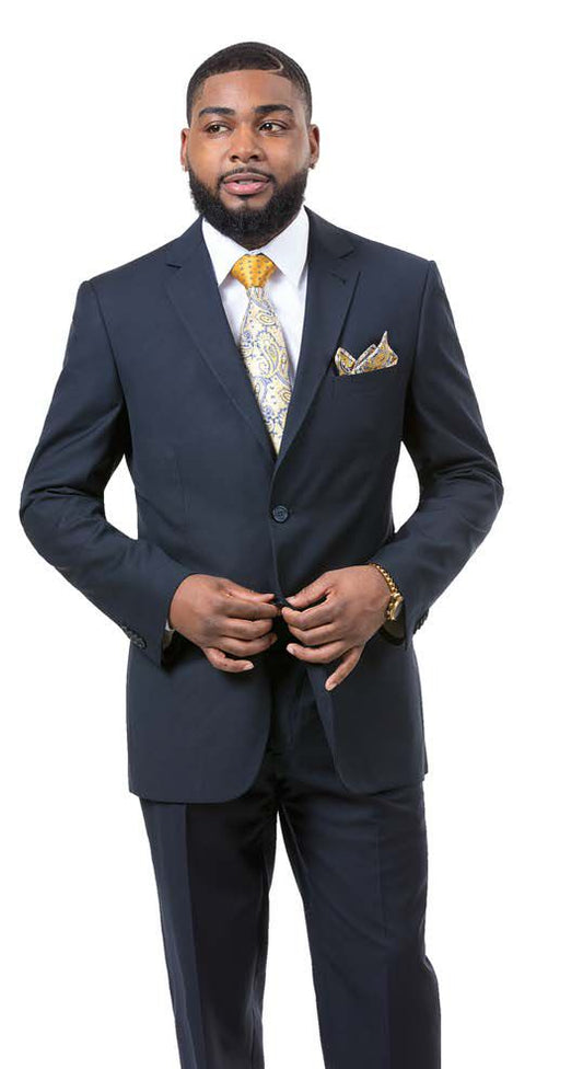 A man in an EJ Samuel Navy Slim Fit Suit M18020, featuring a classic notch lapel and coordinated with a patterned tie, poses against a white background. He exudes elegance, complemented by a finely crafted matching pocket square from the renowned brand EJ SAMUEL.