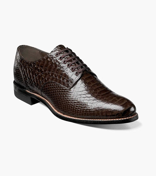 The STACY ADAMS Madison Anaconda Plain Toe Oxford in brown (00055-200) is shown at an angle, highlighting its glossy anaconda print leather, textured snakeskin pattern, black sole, and classic Goodyear welt construction.