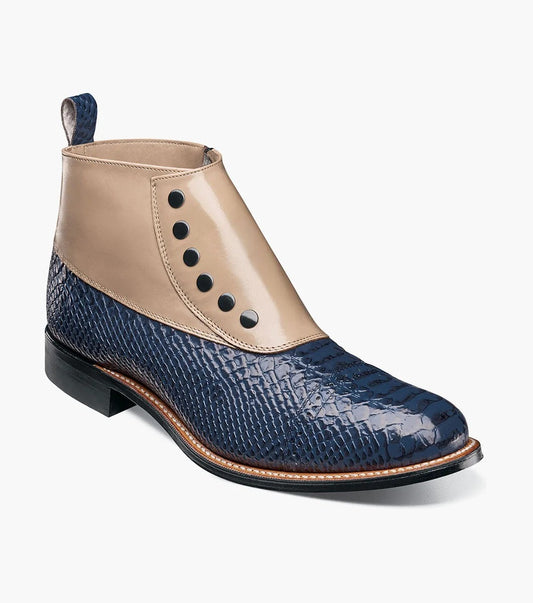 The STACY ADAMS Madison Spectator Spat Cap Toe Demi Boot (Blue Multi) features beige kidskin at the top, blue reptile-patterned leather, black buttons, and a low black heel.