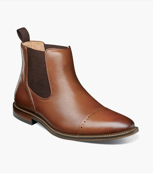 The STACY ADAMS Maury Cap Toe Chelsea Boot in Chocolate (25492-202) features burnished leather, elastic side panel, heel pull tab, anatomical arch support, and decorative toe perforations, pictured against a white background.