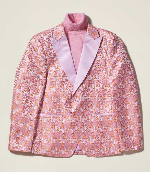 An Inserch Mini Floral Jacquard Peak Lapel Blazer BL203-62 in pink is layered over a matching pink turtleneck.