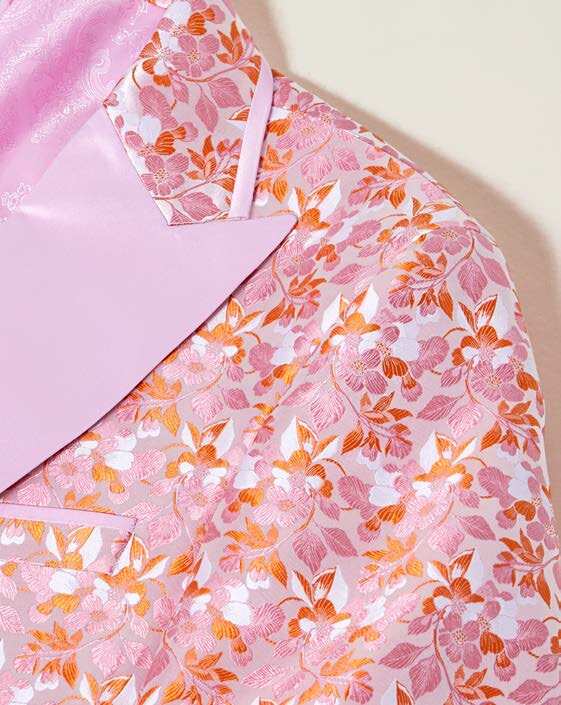 An Inserch Mini Floral Jacquard Peak Lapel Blazer BL203-62 in pink is layered over a matching pink turtleneck.