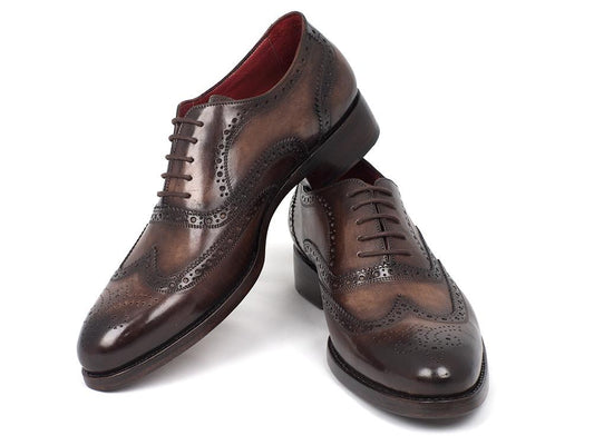 A pair of Paul Parkman Wingtip Oxfords Goodyear Welted Brown - 027-BRW, featuring intricate brogue detailing and Goodyear welted soles, is captured on a white background.