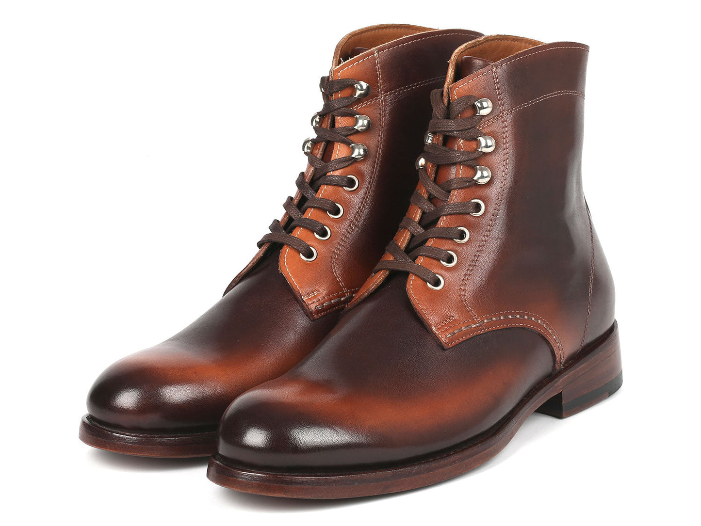 The Paul Parkman Men's Brown Burnished Leather Boots - 824BRW73 showcase a polished finish with silver eyelets and stacked heels, crafted from hand-painted calfskin, against a white background.