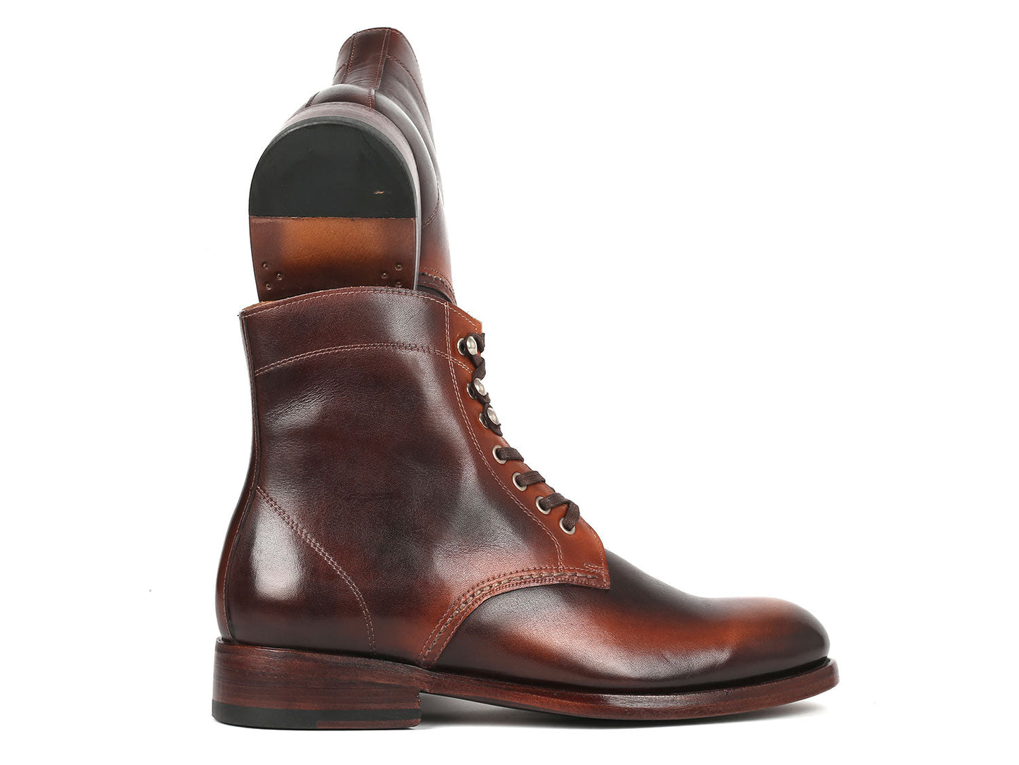 The Paul Parkman Men's Brown Burnished Leather Boots - 824BRW73 showcase a polished finish with silver eyelets and stacked heels, crafted from hand-painted calfskin, against a white background.