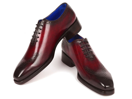 The Paul Parkman Goodyear Welted Punched Oxfords Bordeaux - 7614-BRD highlights exquisite craftsmanship, featuring polished burgundy leather crafted from Bordeaux burnished calfskin, decorative perforations, and a blue lining set against a white background.