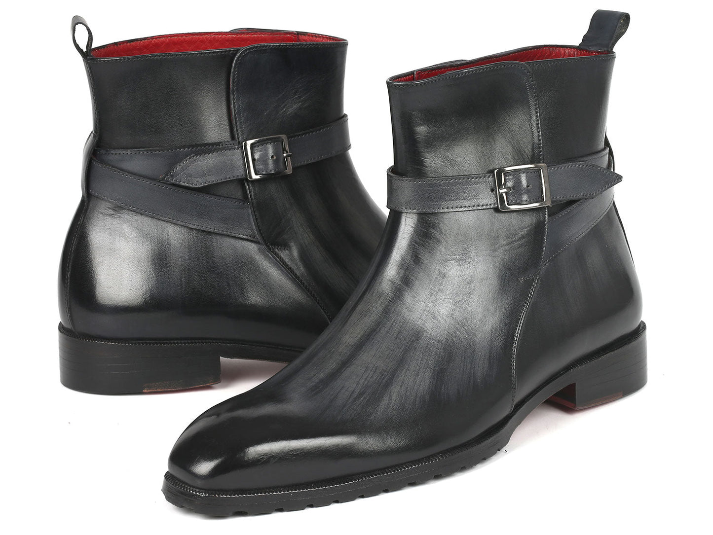 Two gray patina Jodhpur boots from Paul Parkman with a sleek, made-to-order design and a strap detail around the ankle.