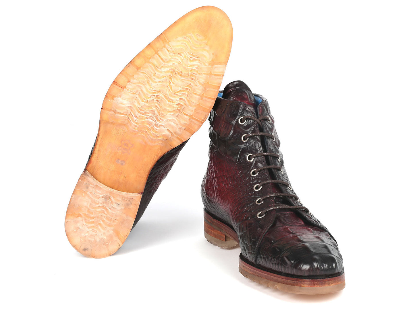 A pair of Paul Parkman Men's Bordeaux Croco Embossed Leather Boots, model 12811-BRD, presenting a striking red and black pattern with a lace-up design, showcased on a pristine white background.
