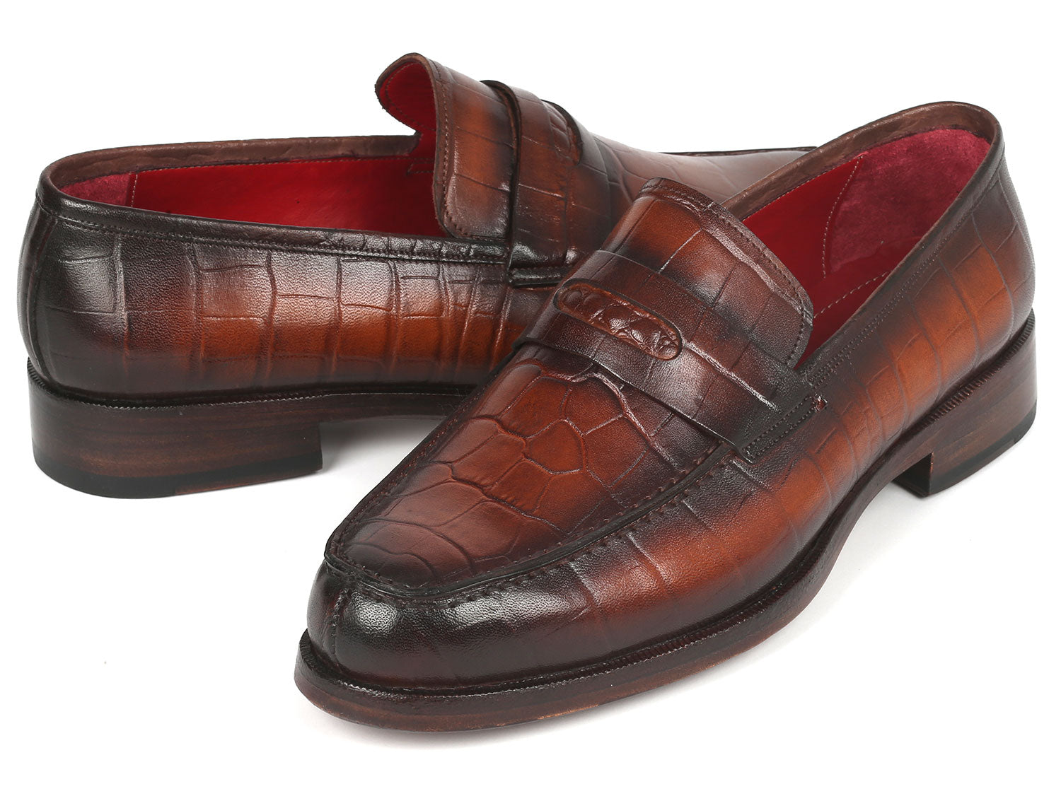 Paul Parkman Brown Crocodile Embossed Calfskin Penny Loafers - 3857-BRW, featuring a striking red interior lining, are showcased on a white background.