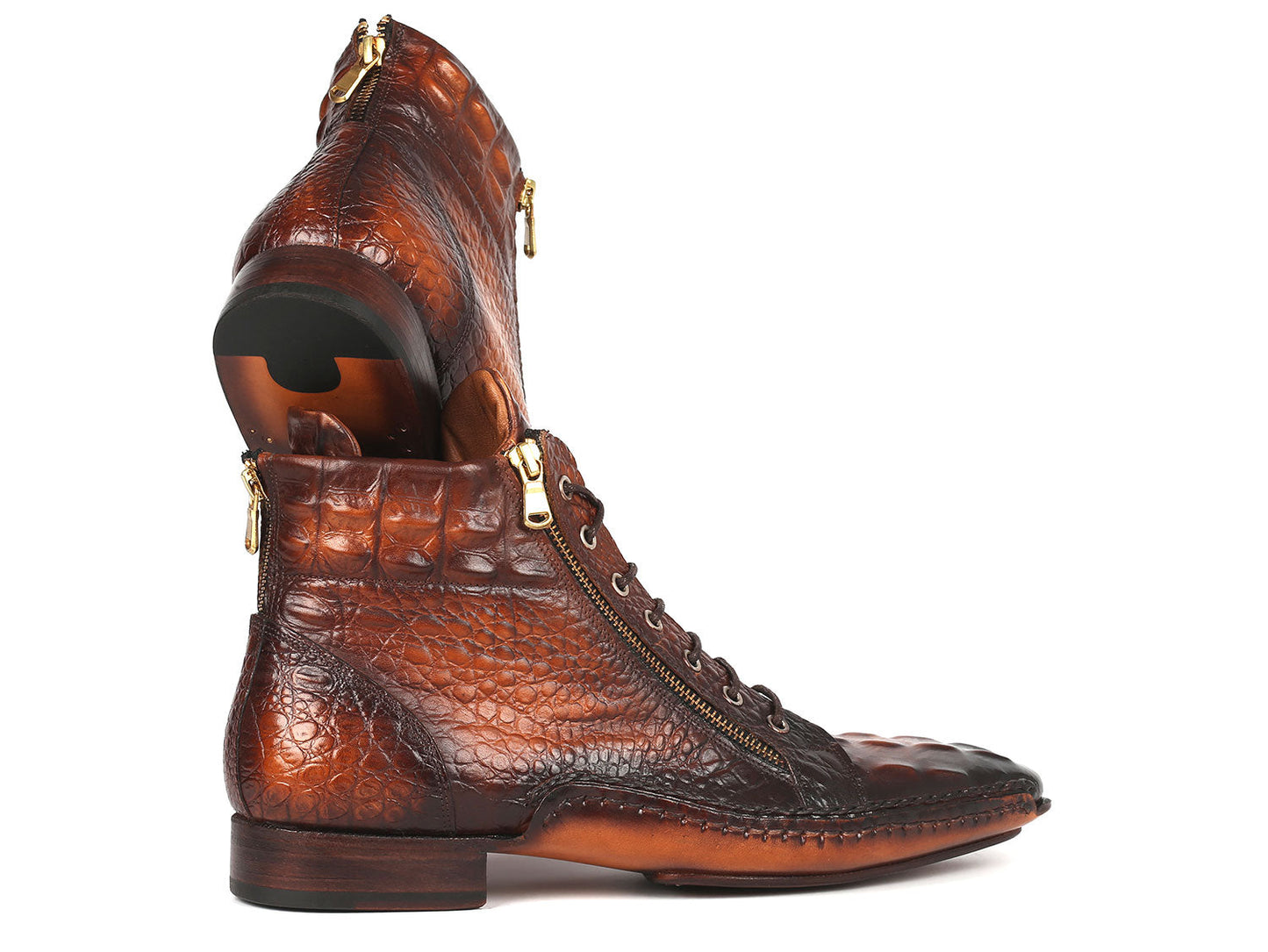 A pair of Paul Parkman Crocodile Textured Calfskin Handmade Zipper Boots - 88APK87, showcasing a rich brown color with hand-sewn crocodile texture, front lacing, and side zippers, stacked with one leaning against the other.