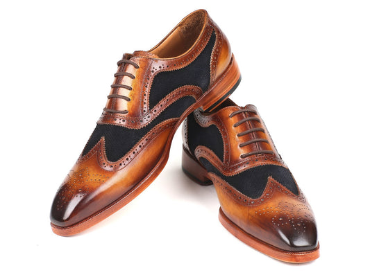 A pair of Paul Parkman Brown Leather & Navy Suede Oxfords - 228NV65, featuring intricate perforations, are elegantly laced and displayed on a pristine white surface.