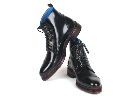 A pair of Paul Parkman Polished Leather Boots in glossy black, model 5075-BLK, showcasing a sophisticated hand-welted construction and contrasting brown soles, with one boot elegantly resting on its heel.
